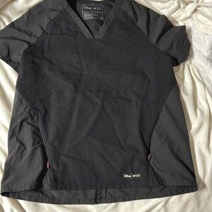 Woman’s FIGS scrub top.